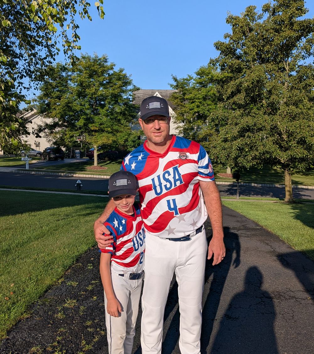 Clint and his son in matching baseball uniforms